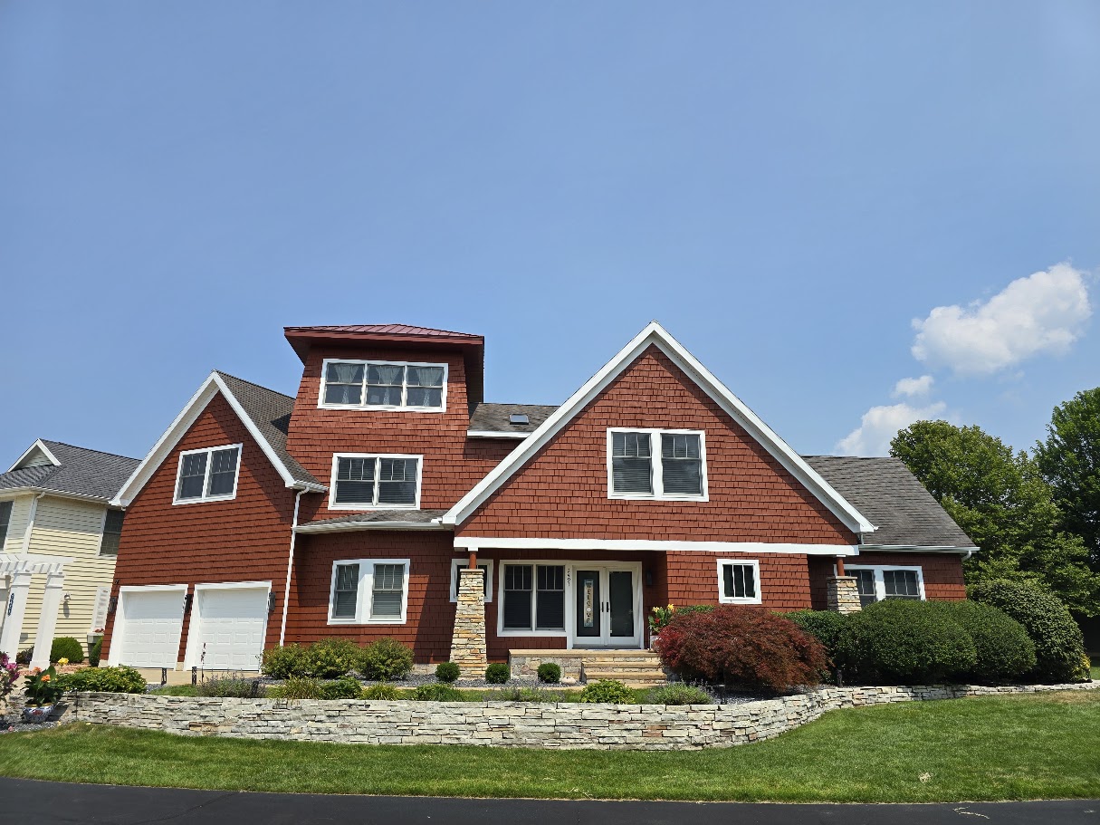 Red shingle house with white trim, viewed from the front